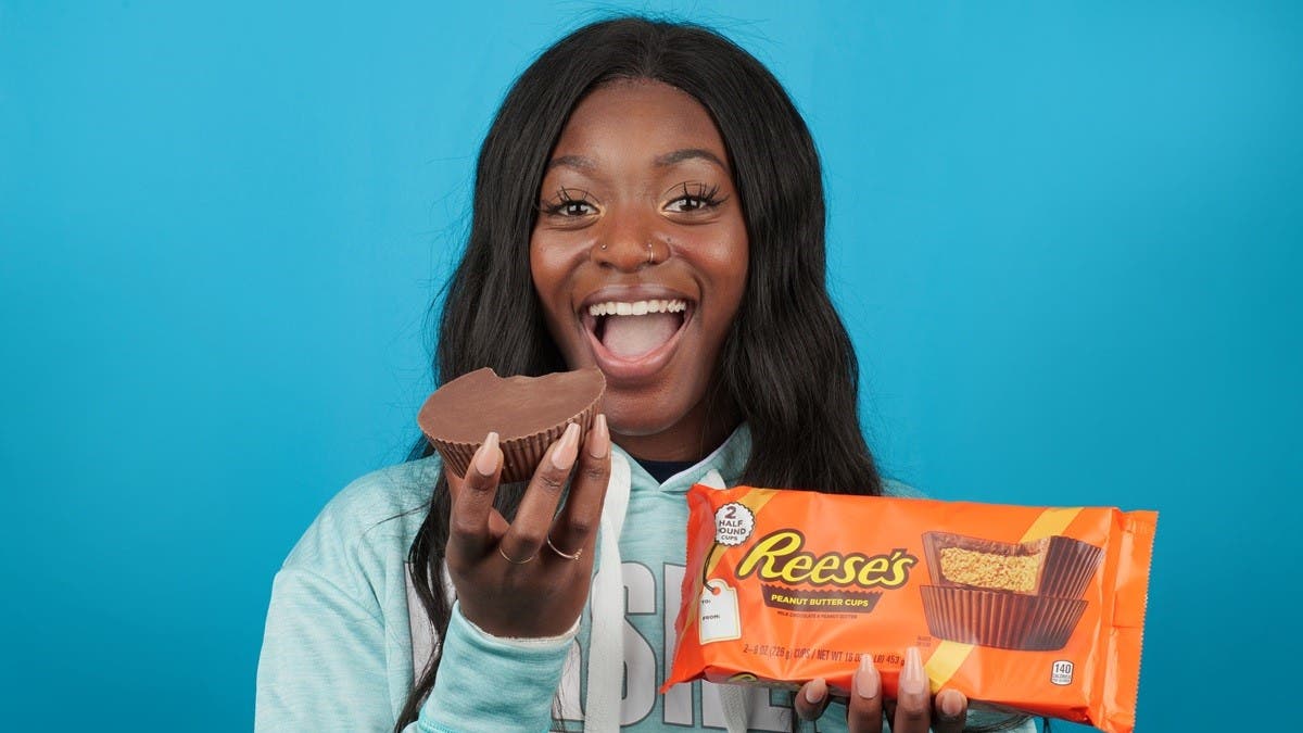 Woman holding World's Largest REESE'S Peanut Butter Cup