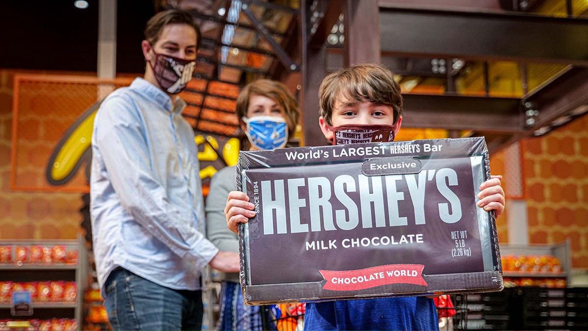 Child holding giant Hershey's Chocolate Bar