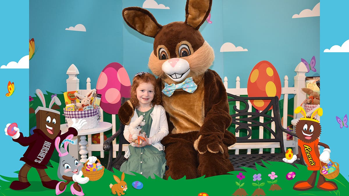 Easter Bunny posing for photo with child